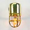 Shop for a small brass nautical wall light. Reclaimed from old ships and restored. This small vintage wall light features a brass cage and tempered glass which covers and protects the lamp holder. Can be used both as small indoor lighting or small outdoor lighting