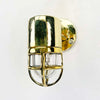 Shop for a small brass nautical wall light. Reclaimed from old ships and restored. This small vintage wall light features a brass cage and tempered glass which covers and protects the lamp holder. Can be used both as small indoor lighting or small outdoor lighting