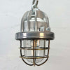 small reclaimed ceiling cage lights in aluminium and brass hanging over a rustic dining table. Suitable to use as kitchen or bathroom lighting