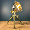 Shop for a steampunk style floor lamp. Comprised of a searchlight which has been expertly modified to integrate seamlessly with the tripod, secured by three brass thumb screws for stability and functionality. A cast brass Wiska rotary marine isolator switch provides a reliable and straightforward mechanism for operating the lamp.