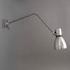 A Czechoslovakian wall-mounted vintage industrial cantilever wall lamp with adjustable arm on a gray background made by Elektrosvit