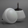 White opaline glass pendant light with a dark brown Bakelite fixture on a gray background