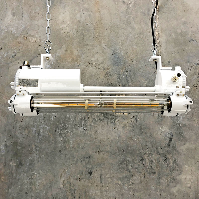 A white vintage industrial ceiling striplight refurbished and modified with Edison LED tubes. These flameproof industrial fixtures were made c1970 by Daeyang a Korean manufacturer of industrial fixtures.