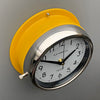 A non-ticking yellow circular wall clock with white face, reclaimed and restored by AC.GMT.Co.
