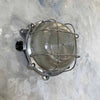 Vintage industrial round outdoor bulkhead light with prismatic glass and protective cage, can also be used as industrial style wall lighting for interiors too.