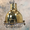 A vintage brass dome ceiling pendant light fixture with an aluminium industrial style cage.