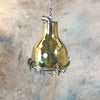 A vintage brass dome ceiling pendant light fixture with an aluminium industrial style cage.
