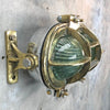 A vintage industrial brass and aluminium tilting wall bulkhead wall light with prismatic glass.