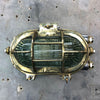 A vintage industrial brass and aluminium tilting wall bulkhead wall light with prismatic glass.
