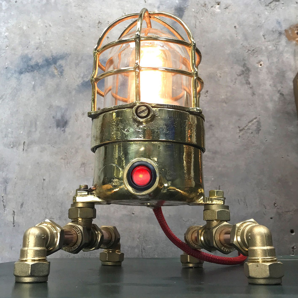 A vintage industrial 1970's brass explosion proof passage way light modified into a steampunk style table lamp. 