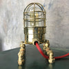 A vintage industrial 1970's brass explosion proof passage way light modified into a steampunk style table lamp.