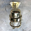 A reclaimed retro industrial solid brass 90 degree outdoor wall light with protective cage.