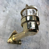 A reclaimed retro industrial solid brass 90 degree outdoor wall light with protective cage.