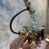 A vintage industrial style copper swing arm wall light with brass explosion proof pendant light.