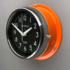A non-ticking orange nautical style wall clock with black face, reclaimed and restored by AC.GMT.Co.