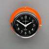 A non-ticking orange nautical style wall clock with black face, reclaimed and restored by AC.GMT.Co.