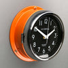 A non-ticking orange nautical style wall clock with black face, reclaimed and restored by AC.GMT.Co.