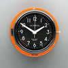 A non-ticking orange nautical style wall clock with black face, reclaimed and restored by AC.GMT.Co.