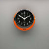 A non-ticking orange nautical style wall clock with black face, reclaimed and restored by AC.GMT.Co.