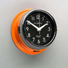 A non-ticking orange nautical style wall clock with black face, reclaimed and restored by AC.GMT.Co.