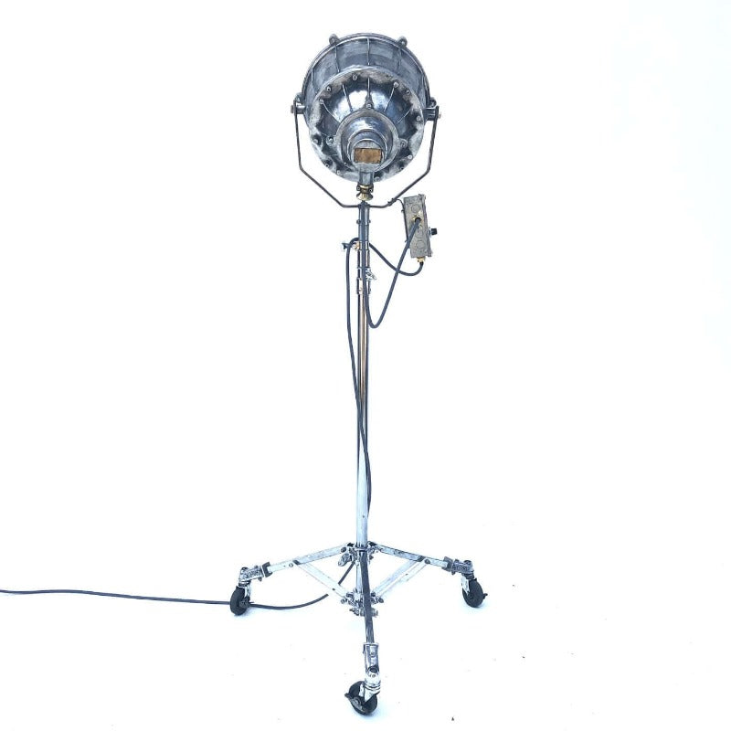 Retro industrial aluminium explosion proof cargo light with a telescopic Matthews theatre stand to create a large bespoke floor standing lamp.