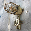 A vintage industrial Wiska industrial brass wall light with a protective brass wire cage & junction box.