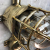 A vintage industrial Wiska industrial brass wall light with a protective brass wire cage & junction box.