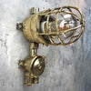 A vintage industrial Wiska industrial brass wall light with a protective brass wire cage & junction box.