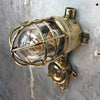 A vintage industrial Wiska industrial brass wall light with a protective brass wire cage & junction box.