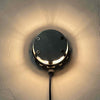 vintage industrial taxiway lamps restored as wall lighting. They produce illumination which washes around the wall.