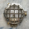 A reclaimed nautical circular solid cast aluminium bulkhead with brass fittings