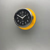A silent yellow circular wall clock with black face, reclaimed and restored by AC.GMT.Co.