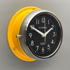 A silent yellow circular wall clock with black face, reclaimed and restored by AC.GMT.Co.