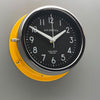 A silent yellow circular wall clock with black face, reclaimed and restored by AC.GMT.Co.