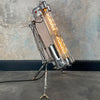 steampunk style aluminium floor lamp with tripod legs and Edison filament LED light bulbs in flameproof glass tubes