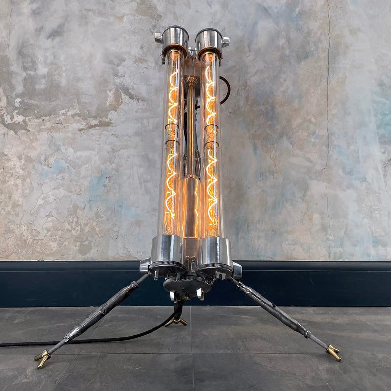 steampunk style aluminium floor lamp with tripod legs and Edison filament LED light bulbs in flameproof glass tubes