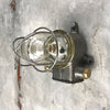 A reclaimed vintage industrial explosion proof outdoor iron wall light with cage, made c1970.