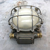 A vintage industrial circular frosted iron wall bulkhead light.