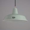 a 1950s mint green enamel industrial pendant light by REVO on a grey background. 