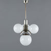 Modern chandelier with three spherical glass lights on a gray background