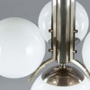 1920s Art Deco Opaline Globe Chandelier featuring 4 milk glass globes on a pewter ballust mounted to the ceiling