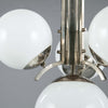 close up of milk glass globes with pewter ballust