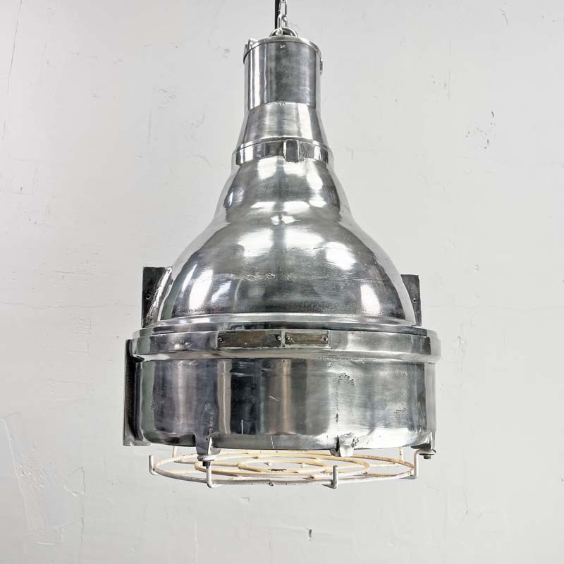 The large explosion proof cast aluminium pendant light was made by the Indian company Baliga Lighting Equipments Ltd. It is a very heavy solid metal light fixture which features a cage over the tempered glass lens that protects the lamp holder from external elements.&nbsp;
