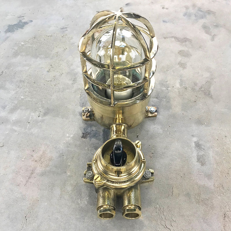 Vintage industrial brass explosion proof light with isolator switch by Wiska. Suitable for outdoor use. Features a cast brass protective cage. Original industrial lighting. 