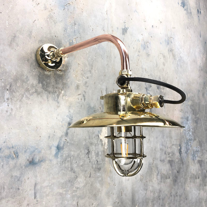 Vintage industrial style cantilever wall light with brass explosion proof cage light suspended to a copper pipe wall arm and brass wall fixing plate. Compatible with LED light bulbs. Restored & rewired ready to install.