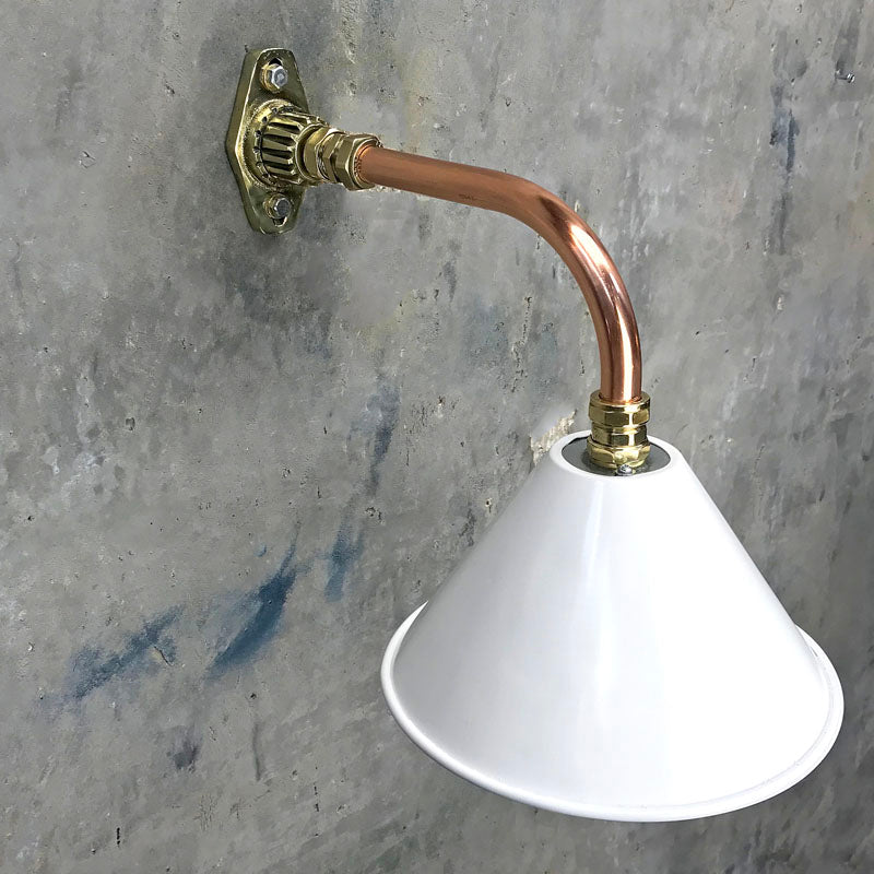 A white cantilever wall light with copper & brass wall fixture
