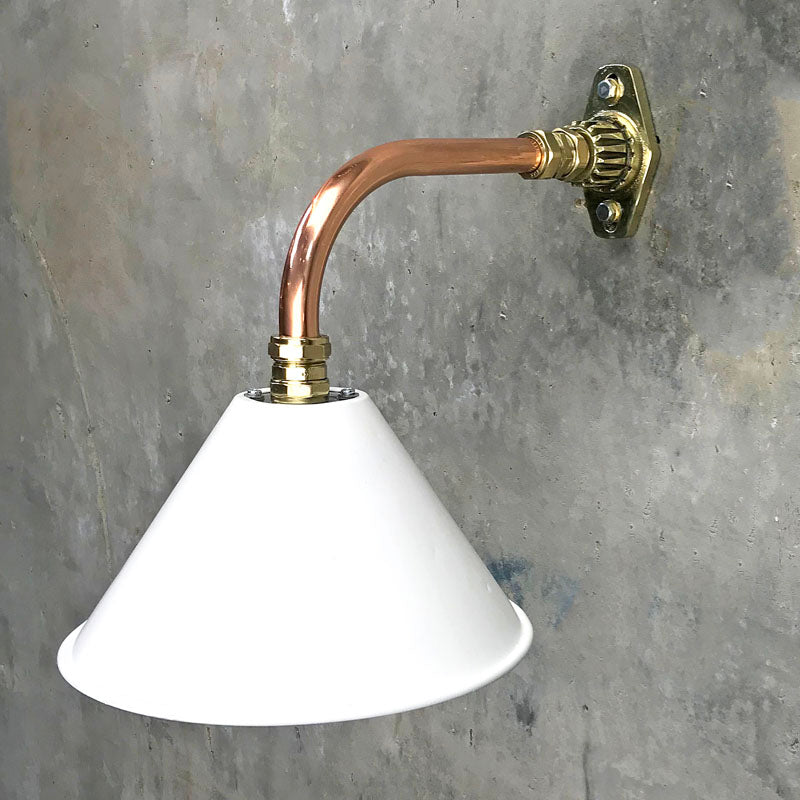 A white cantilever wall light with copper & brass wall fixture