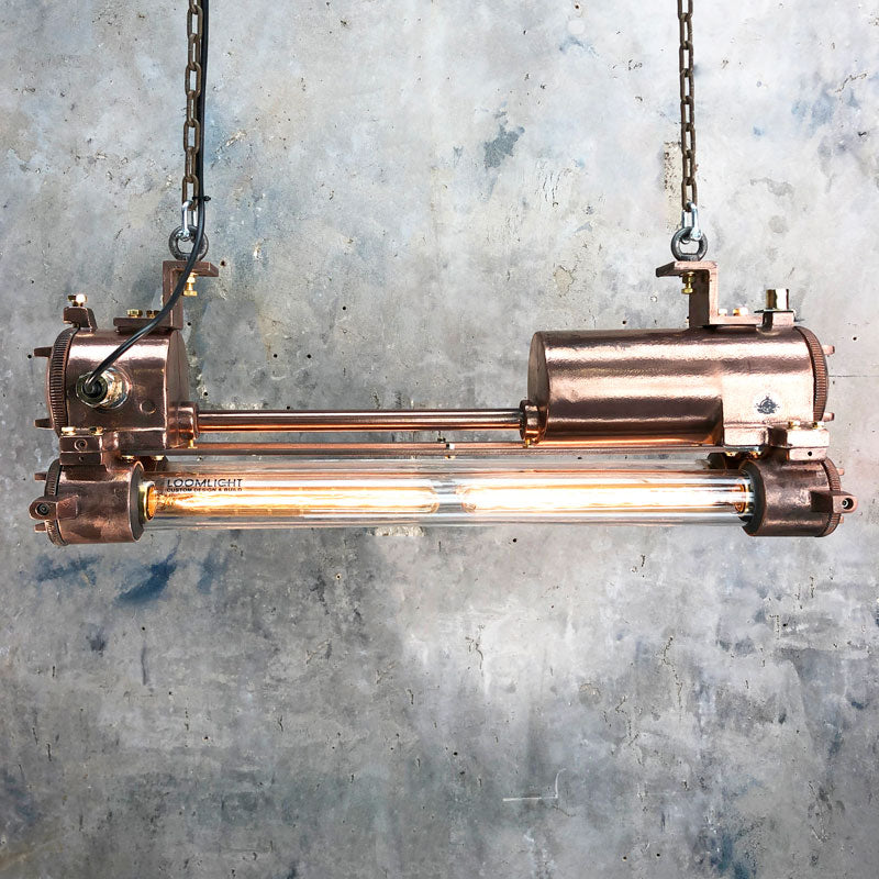 Shop our copper tube light, a reclaimed ceiling light professionally restored. This vintage industrial flameproof light is fitted with LED Edison tubes. We ship worldwide. 