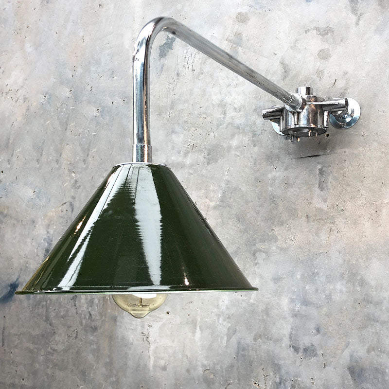 An industrial style green cantilever wall light. The green shade is made in the UK and is based on the design of the British military festoon shades. The shade is fixed to a bespoke galvanised steel cantilever wall fixture made by Loomlight. 