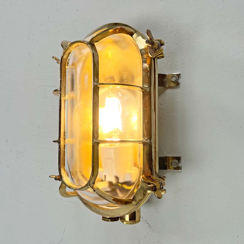 a vintage brass wall sconce which is an industrial wall light professionally restored for modern interiors. Fitted with LED light bulbs this cast brass wall light is ideal for creating industrial style interiors.
